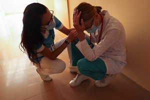 Nurse calms crying doctor