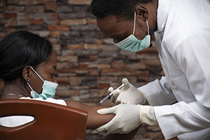african doctor injecting patient