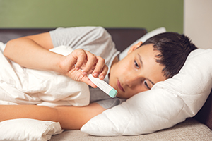 boy in bed with fever
