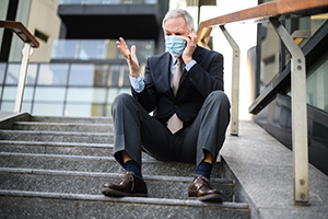 businessman with mask on phone