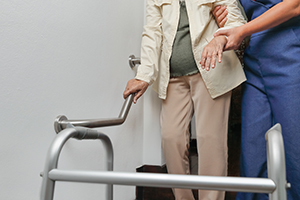 caregiver helping elderly woman