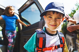 child in hat with mask