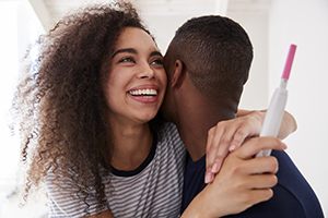 couple celebrating pregnancy test