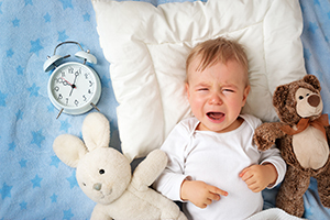 crying baby with alarm clock