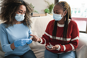 doctor in gloves at home with patient