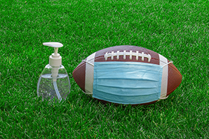 football with mask and sanitizer