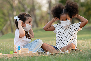 little girls putting on masks