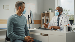 masked patient with doctor