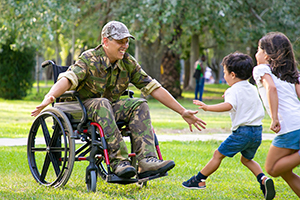 military person greeting children