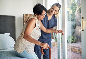 elderly woman getting assistance to walk