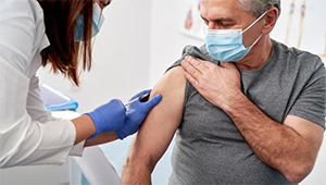 older man getting vaccine