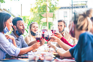 people drinking wine with masks