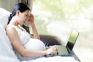 pregnant woman on laptop