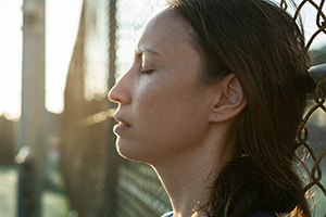 woman leaning against fence