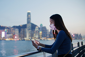 woman with mask looking over skyline